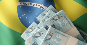 Brazilian real banknotes over Brazil flag