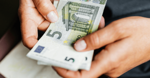 Woman holding 5 euro bill